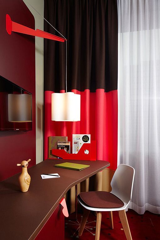 Rincón de trabajo de la habitación roja del 25 Hours, un hotel moderno en Zürich Rincón de trabajo de la habitación roja del 25 Hours, un hotel moderno en Zürich